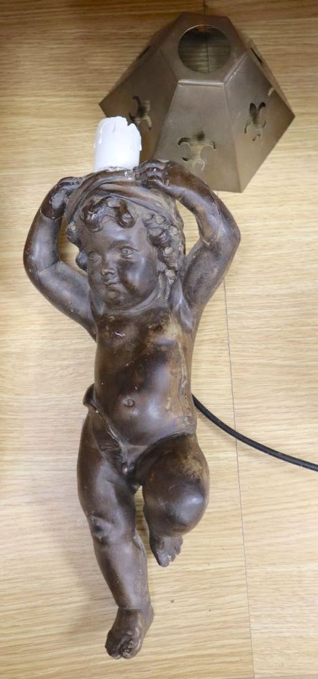 A plaster cherub candlestick, converted to a lamp